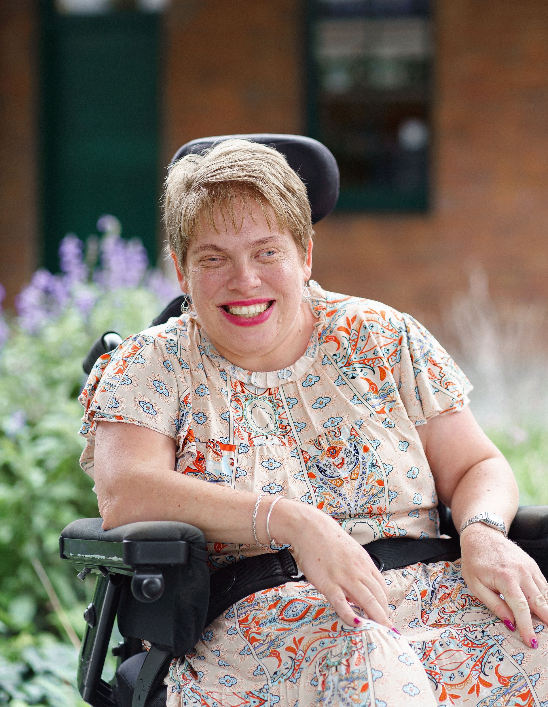 Image description: Melanie Schlaeger smiling in front of lavendar bushes