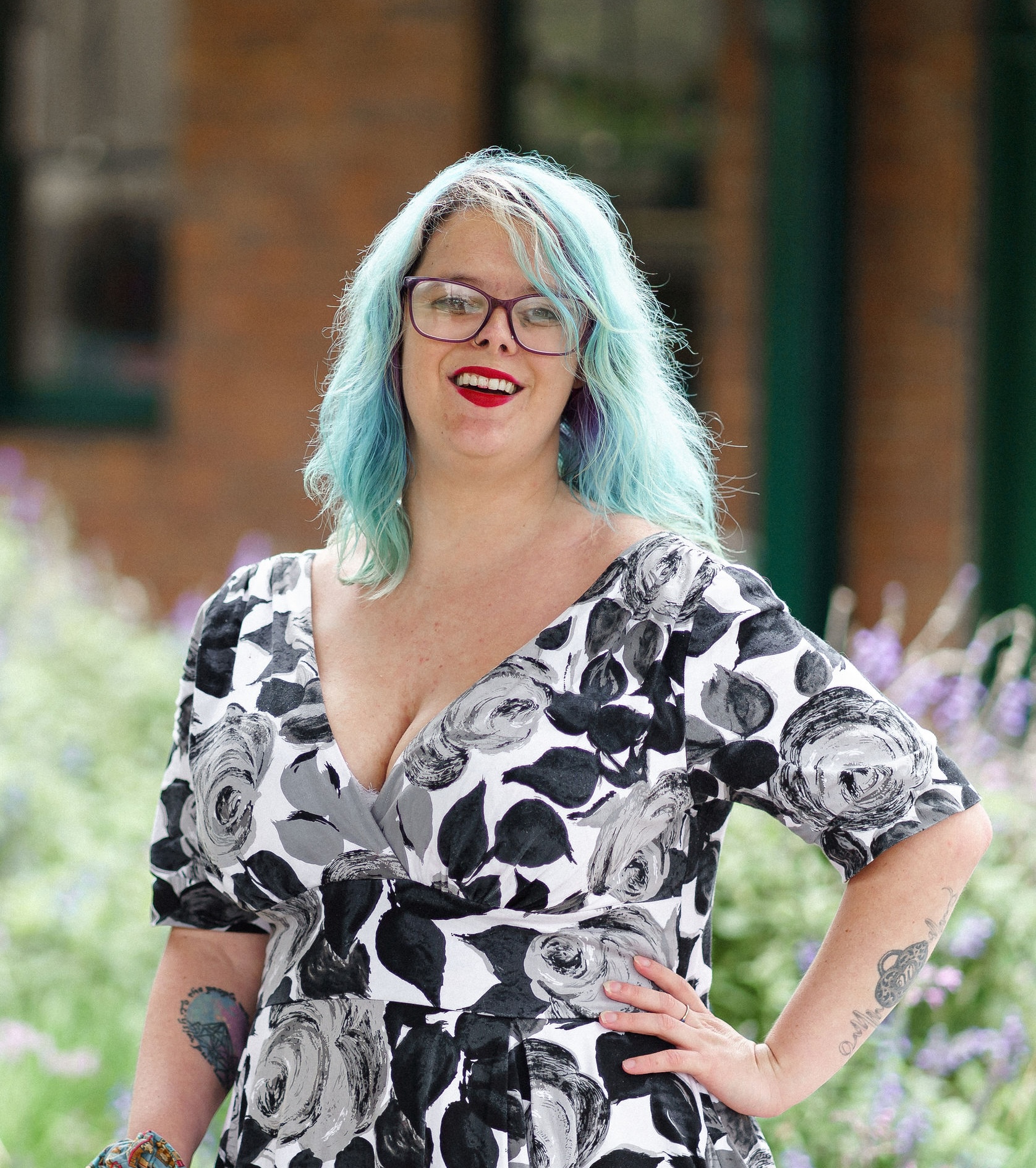 Image description: Shaylie Pryer smiling and posing in front of lavendar bushes